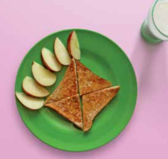 Apple segments on a plate with toast and a glass of milk