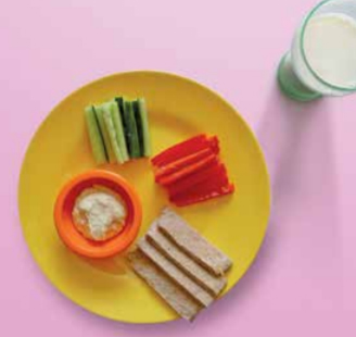 Sticks of cucumber, red pepper and pitta bread with a pot of houmous and a glass of milk