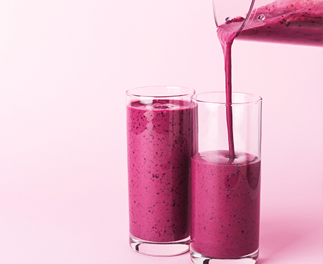 Image of jug pouring smoothie into two glasses