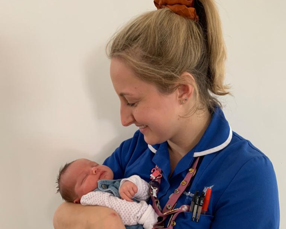 Emilie holding a sleeping baby