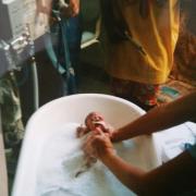 Sophie being bathed for the first time