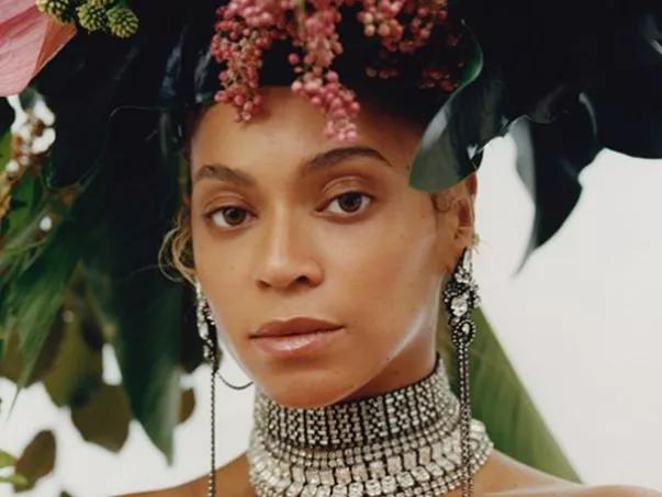 A photo of Beyonce modelling for Vogue with flowers and tropical leaves in her hair